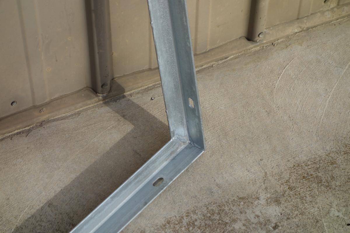 Close up of the mounting frame welded connections. Holes are provided on two sides of the frame to allow for the alternate pitch. Slotted holes allow for some slight error in the anchoring hole drilling.